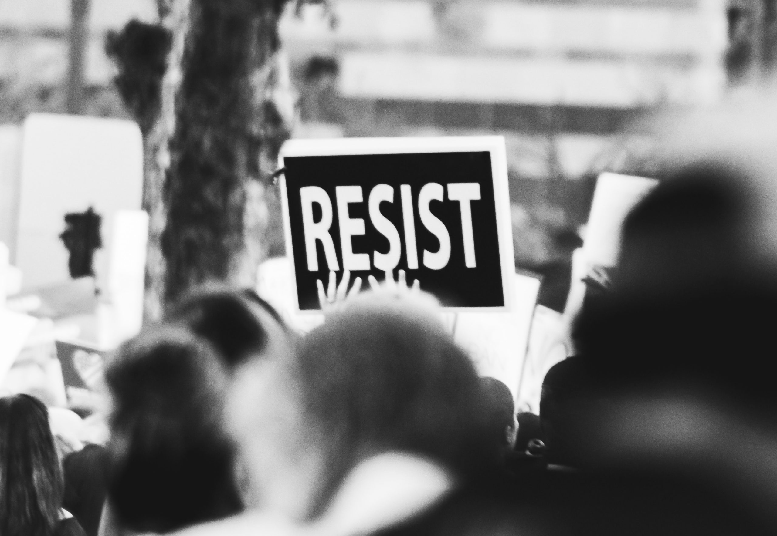 Photo of protest sign that says "Resist"