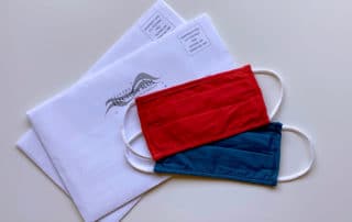 Photo of facemasks, vote-by-mail envelopes