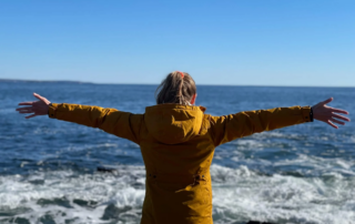 Photo of woman feeling freedom at the ocean