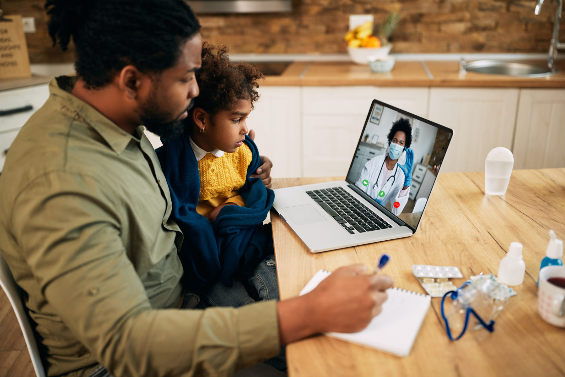Father and daughter on telehealth call